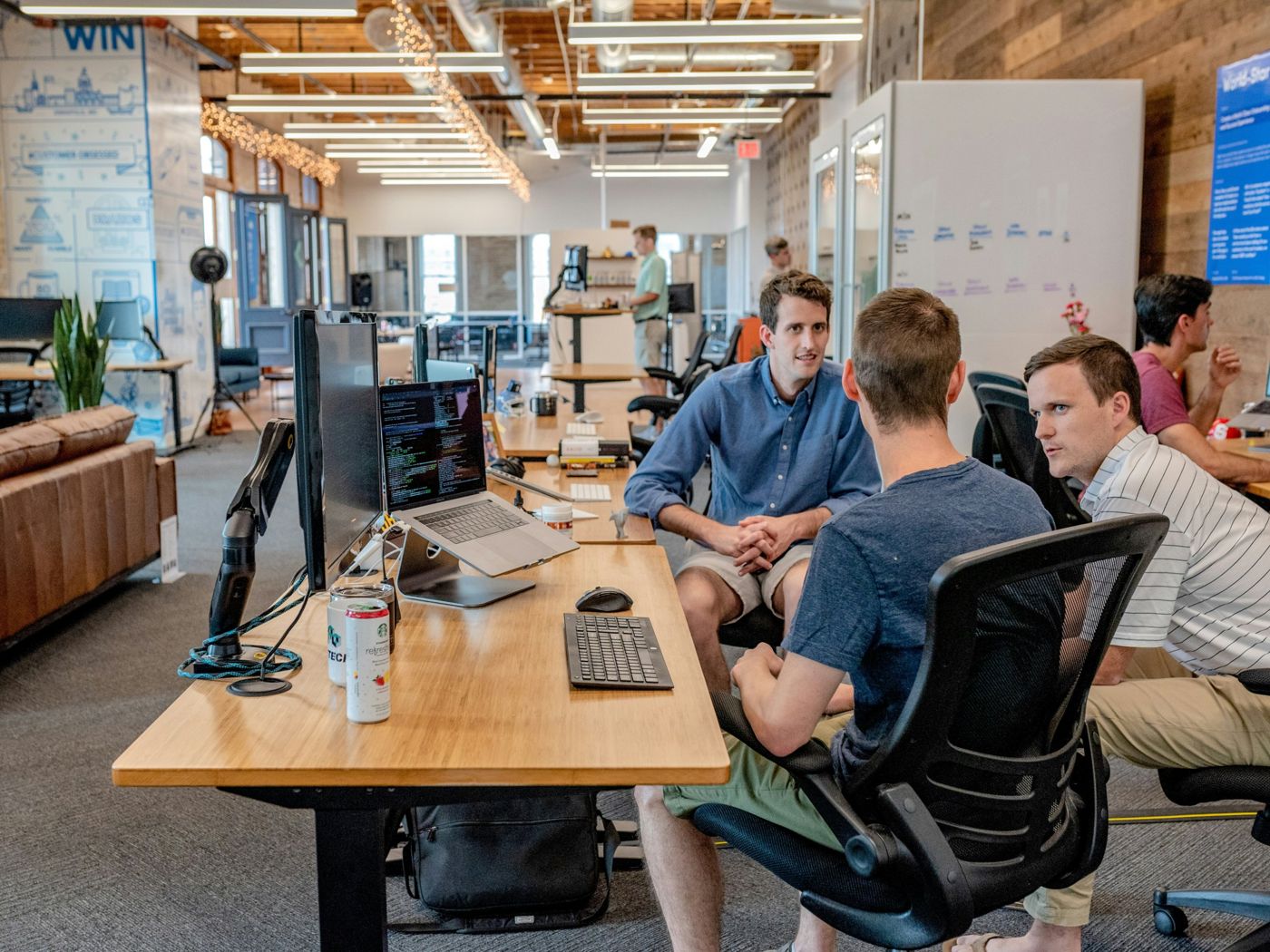 Engineers discussing code in an open-plan office